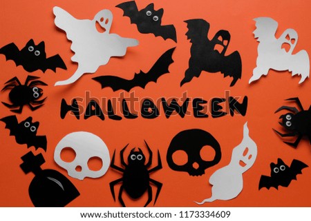 The concept of the holiday of Halloween. bats of the cast and spiders on an orange background. top view