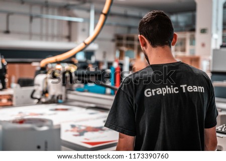 Production manager making sure all prints are perfectly processed and delivered. Royalty-Free Stock Photo #1173390760