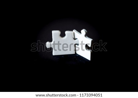 White puzzle on a black background