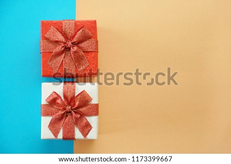 Red and white gift boxes on blur and brown background, picture have space for idea.