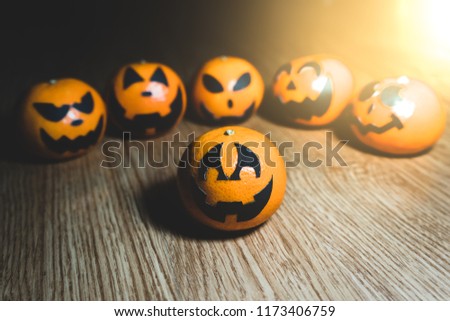 Group of oranges face painting with scary on halloween party day.