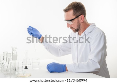 view of a man in the laboratory while performing experiments
