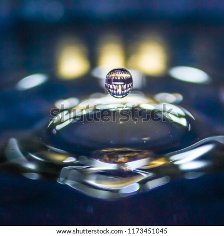 A small water drop fall on water surface and the splash jump to form a good clear, beautiful shape. 