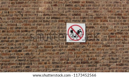 Football not allowed sign on the bricks                             