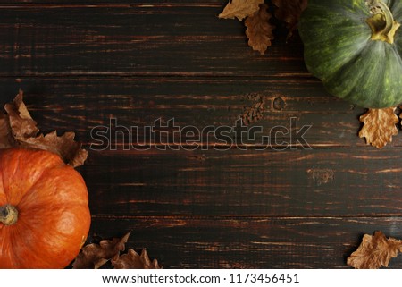 Pumpkin on a wooden table as a symbol of Halloween, Thanksgiving Day. Dark background with copy space.