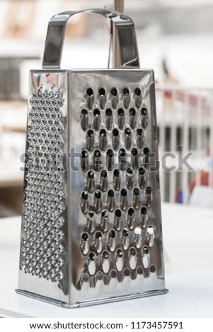 Grater for processing vegetables and fruits. The subject of kitchen utensils. Quick cooking.