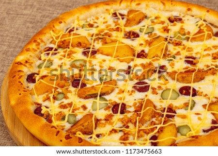 Pizza with sausages, cheese and potato