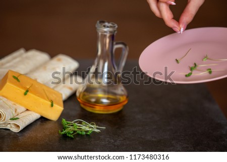 cheese, sunflower oil and thin pita bread lies on a gray stone background