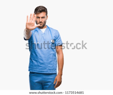 Young handsome doctor surgeon man over isolated background doing stop sing with palm of the hand. Warning expression with negative and serious gesture on the face.