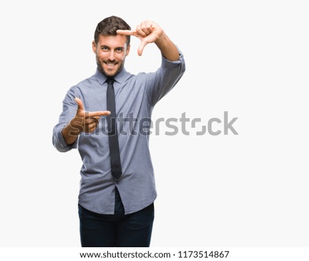 Young handsome business man over isolated background smiling making frame with hands and fingers with happy face. Creativity and photography concept.