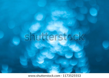Abstract tropical vintage beautiful sea or pool water blurred summer bokeh background caused by sunlight. Blue bokeh light background texture pattern