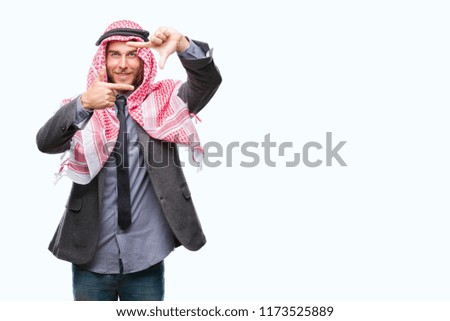 Young handsome arabian man with long hair wearing keffiyeh over isolated background smiling making frame with hands and fingers with happy face. Creativity and photography concept.