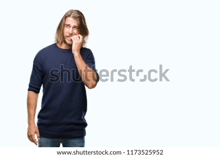 Young handsome man with long hair wearing winter sweater over isolated background looking stressed and nervous with hands on mouth biting nails. Anxiety problem.