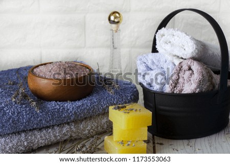 Natural lavender soap and bath salt, French oil and towels on white wooden background