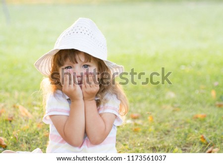 Beautiful little girl in a park on nature. Cute portrait.
