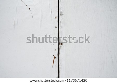stained white painted wood panel with nails screws