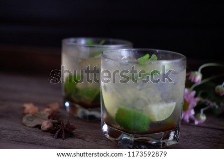 Mojito cocktail on vintage wooden background