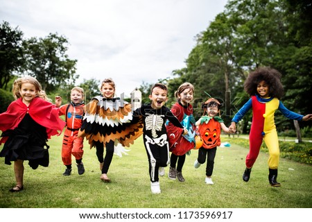 Little kids at a Halloween party Royalty-Free Stock Photo #1173596917