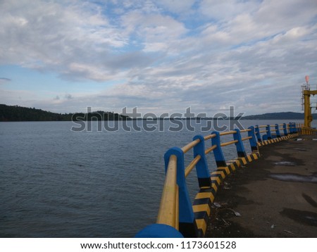 dock with yellow and blue fence above the sea