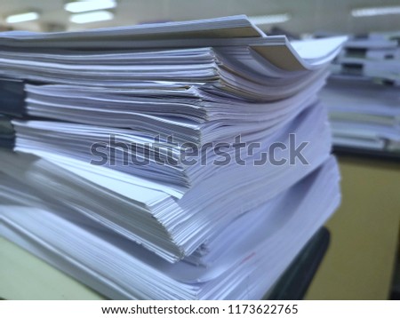 Many reports are piling up in the workplace, Paper stack in the office, Reports of students awaiting examination, Company Financial Statement