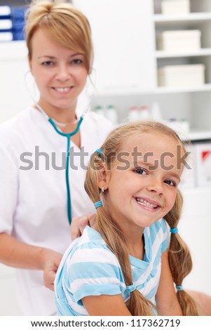 Little girl smiling at the doctor - back after recovery for a checkup