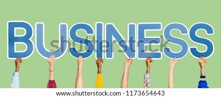 Hands holding up blue letters forming the word business