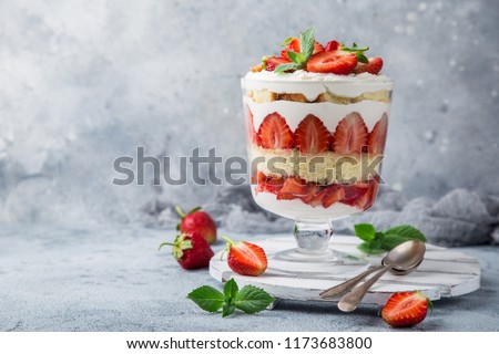 Strawberry trifle. layered dessert with fresh berry and cream cheese, selective focus Royalty-Free Stock Photo #1173683800