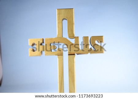 Jesus word written on the wood cross background 