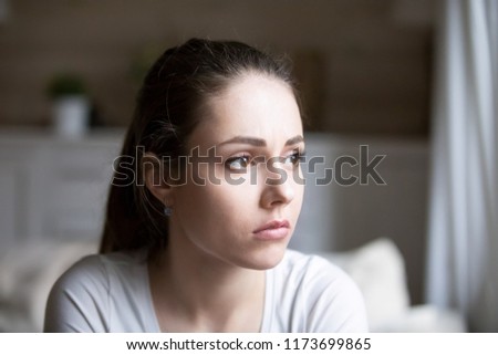 Sad young woman looking in distance thinking about relationships problems, upset hurt girl view from window sorrow about breakup with boyfriend, disappointed female feeling blue having troubles Royalty-Free Stock Photo #1173699865