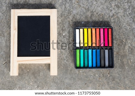 Black board with eel and color chalk board on grey background