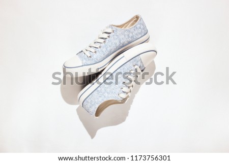 Fashion sneakers on a white background.Photo with shadows, hard light, top view
