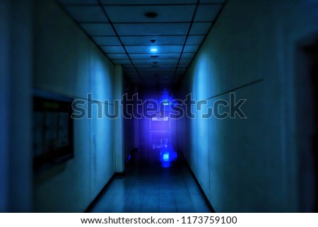 the walkway in the old hotel with purple light at the night time, dark and night concept