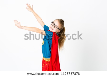 blond girl with glasses and red robe und blue shirt is posing in the studio