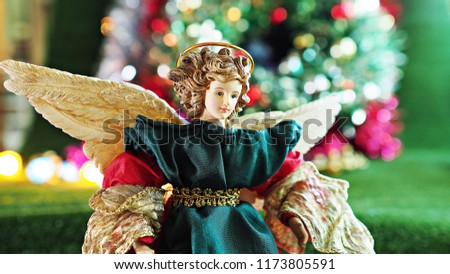 Christmas decoration beautiful angel with wings on colorful background. Holidays greeting cards idea.