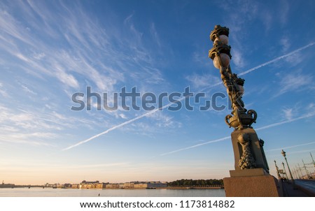 Morning view of the scenic lamp on  Trinity Bridge with cityscape and blue sky background. St.Petersburg, Russia.
