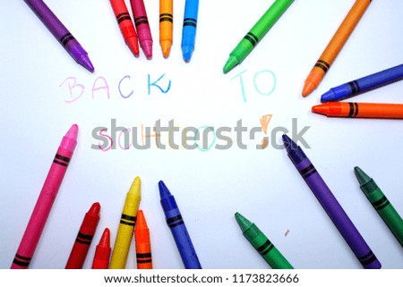 Inscription 'back to school' and crayon on a white background