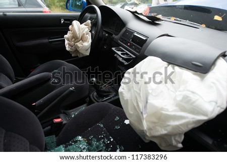 damaged car with deployed airbags Royalty-Free Stock Photo #117383296