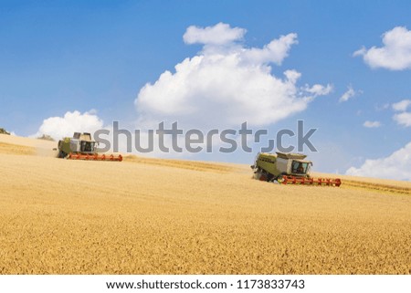 two harvesters during harvest on sunny day