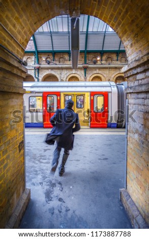 A man running to catch hit train to work in London