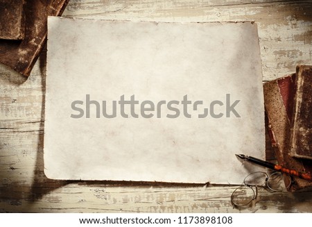 old parchment with books,spectacles and pen on antique writing desk Royalty-Free Stock Photo #1173898108