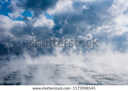 Evaporation at sea. Clouds at sea. Gulf Stream current in Sargasso Sea in winter Royalty-Free Stock Photo #1173908545