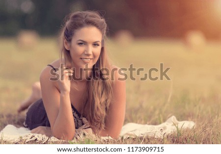 Vintage photo of a beautiful woman in the meadow a summer's day