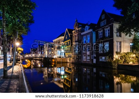 Details of streets, houses, alleys and canals in the old town of Alkmaar in North Holland. Beautifully illuminated city with monuments and locations, photographed in the evening and the night.