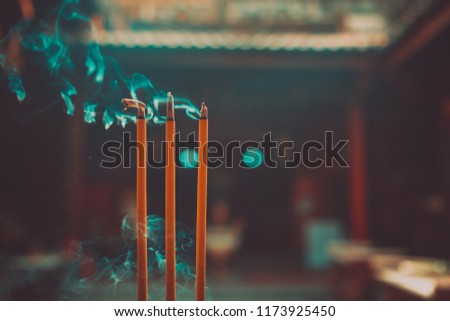 Incense burning in pagoda. Royalty high quality free stock image of incenses burning in garden with blur background. Close focus of incense with copy space for text or advertising