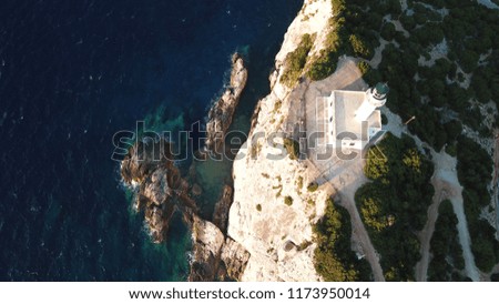 Aerial drone bird's eye view photo of lighthouse built in cliff at sunset
