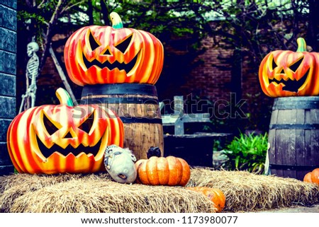 Halloween pumpkin in Graveyard, Skeleton with crosses in Spooky Land, selective focus, vintage toned