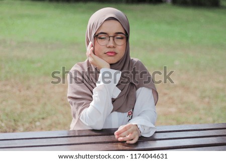 Young cute hijab fashion hijab posing and expression with greenery background.
