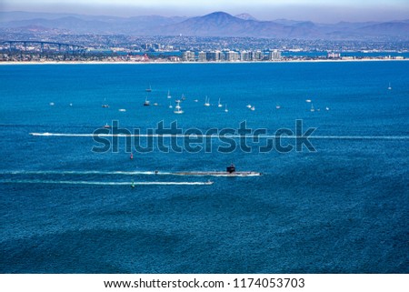 Submarine leaving port with Coronado Island and the city of San Diego, California in the distance