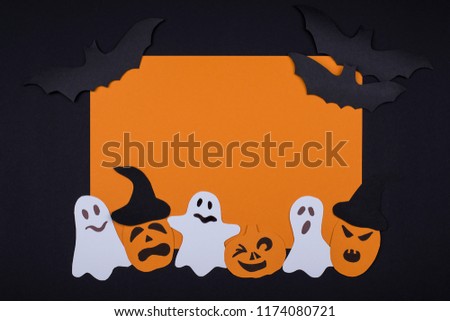 Greeting handmade card for Halloween with smiling scary pumpkins, white ghosts and black bats on a black background with place for text. Flat lay