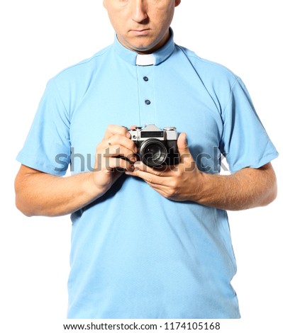 oung priest with the camera on a white background